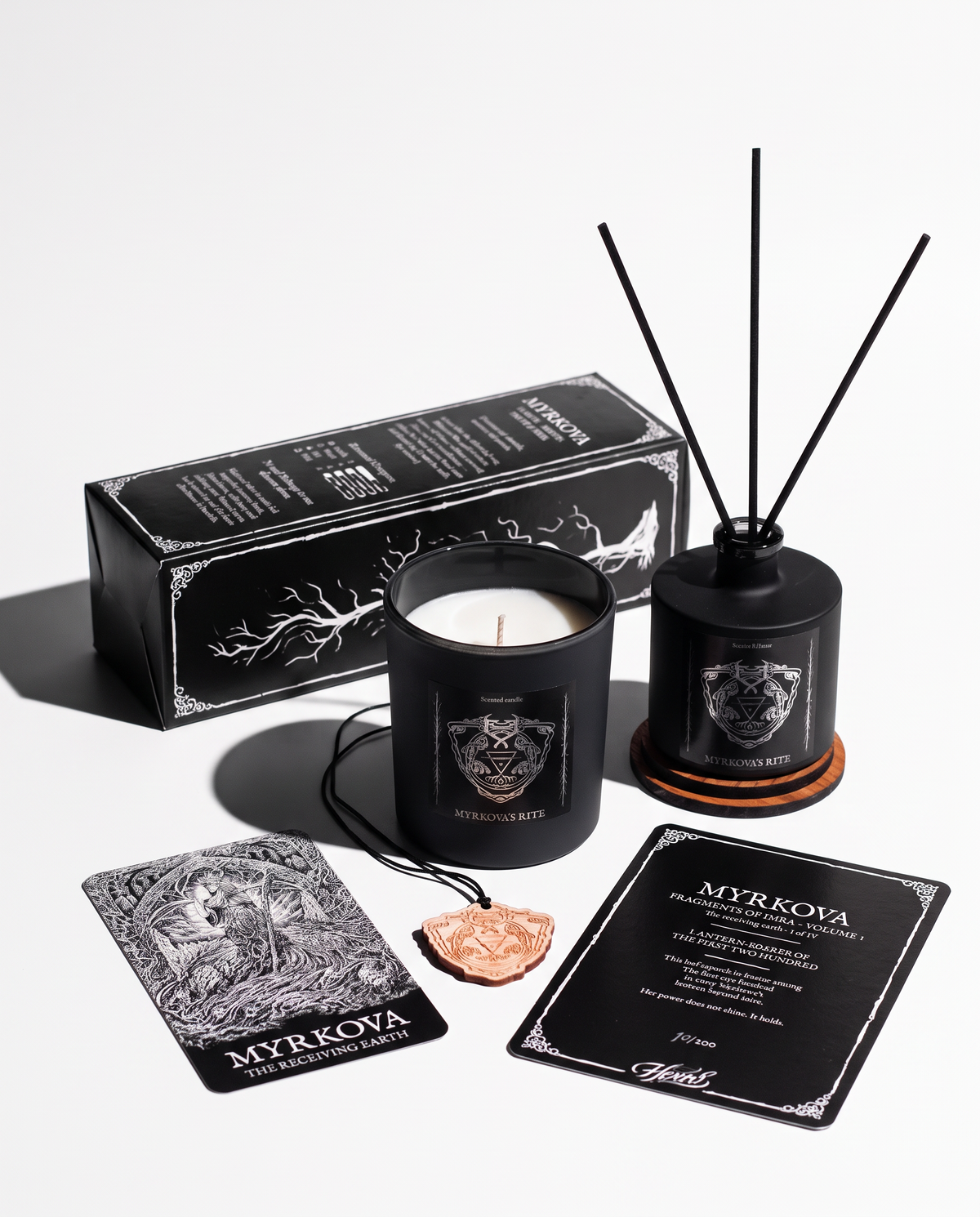Myrkova's Rite First Edition bundle by HEXED on a white background with hard shadows: scented candle, room diffuser, black gift box, numbered lore card, wooden crest pendant and the Myrkova goddess card